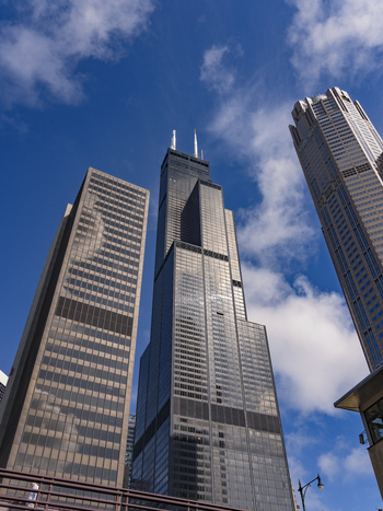 Chicago United States 15 September 2025 View of the Willis Tower skyscraper with its iconic black glass facade reaching into a blue sky with white clouds.