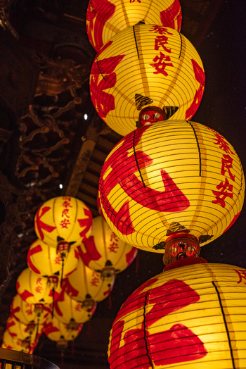 View of traditional yellow paper lanterns with red calligraphy hanging in a row at Ximen in Guangfu Village Taipei City Taiwan. View of traditional yellow paper lanterns with red calligraphy hanging in a row at Ximen in Guangfu Village Taipei City Taiwan.
