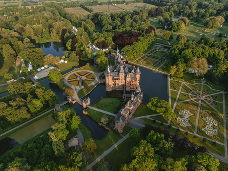 Aerial view of De Haar Castle featuring medieval architecture and pointed towers surrounded by a water moat and manicured formal gardens with geometric patterns Utrecht Utrecht Netherlands. Aerial view of De Haar Castle featuring medieval architecture and pointed towers surrounded by a water moat and manicured formal gardens with geometric patterns Utrecht Utrecht Netherlands.