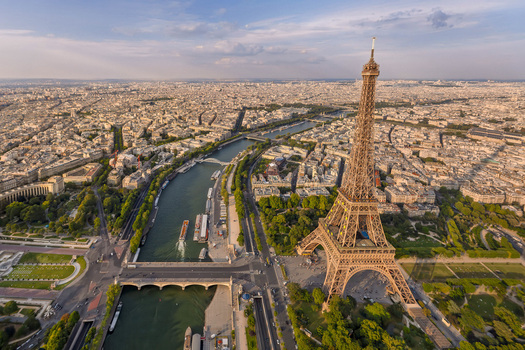 FRANCE. PARIS 75. AERIAL VIEW OF THE EIFFEL TOWER DISPLAYING THE EUROPEAN FLAG STARS WITH THE CHAMP DE MARS AND ECOLE MILITAIRE BEYOND.