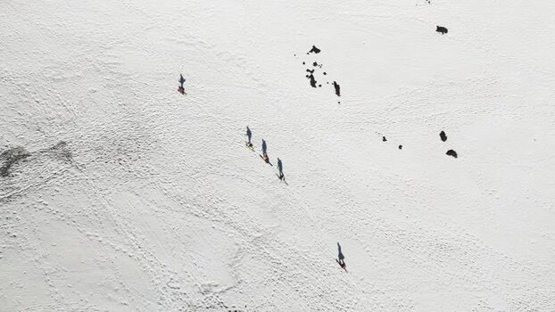 Aerial view of people walking on snow near Rifugio Sapienza Italy. Aerial view of people walking on snow near Rifugio Sapienza Italy.