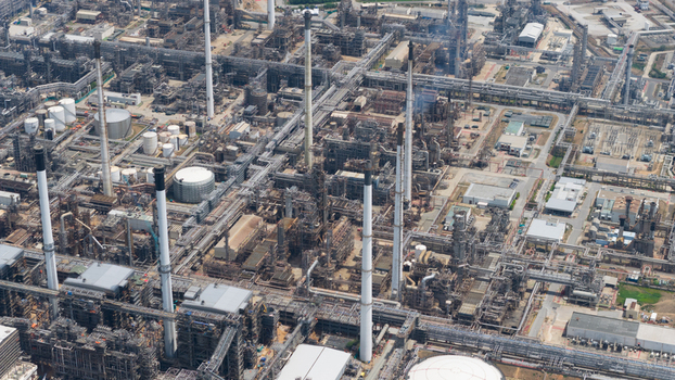 Aerial view of the Laem Chabang oil refinery and petrochemical complex featuring a dense network of industrial pipelines tall smokestacks and storage tanks Laem Chabang Chon Buri Thailand. Aerial view of the Laem Chabang oil refinery and petrochemical complex featuring a dense network of industrial pipelines tall smokestacks and storage tanks Laem Chabang Chon Buri Thailand.