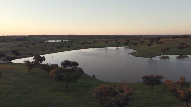 Aerial view of a lake and rolling hills at sunset Portugal. Aerial view of a lake and rolling hills at sunset Portugal.