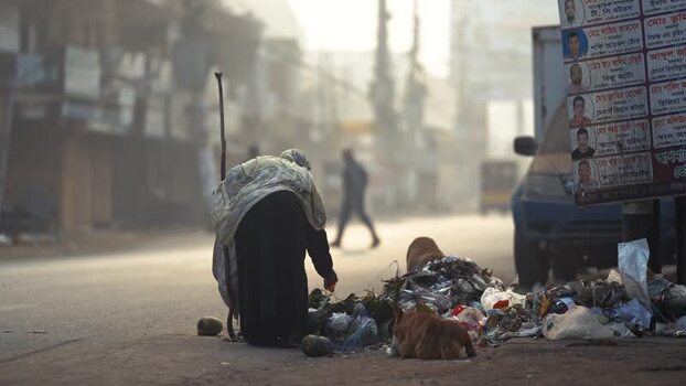 View of an elderly person scavenging trash in Bogura Bangladesh. View of an elderly person scavenging trash in Bogura Bangladesh.