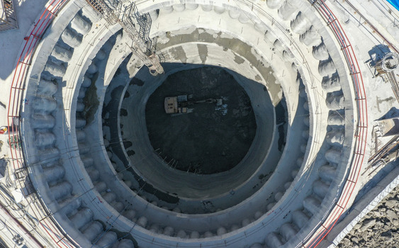 Aerial view of a deep circular construction shaft with an excavator at the bottom and concrete reinforced walls Sariyer Istanbul Turkiye. Aerial view of a deep circular construction shaft with an excavator at the bottom and concrete reinforced walls Sariyer Istanbul Turkiye.