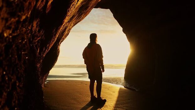 View of a person in a cave entrance New Zealand. View of a person in a cave entrance New Zealand.