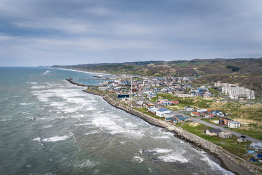 Aerial view of the coastal town with its buildings road and shoreline along the sea in Wakkanai Hokkaido Japan.