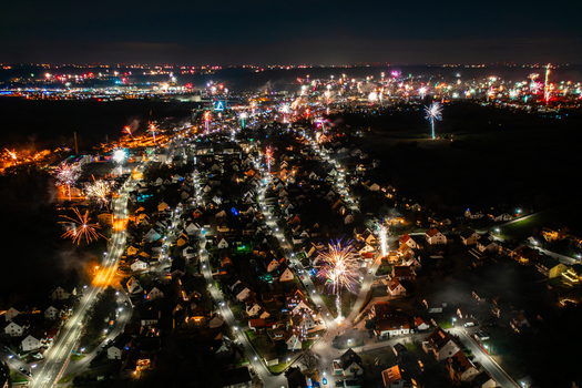 Aerial view of colorful fireworks exploding over the illuminated rooftops and streets of the town at night Forchheim Bavaria Germany. Aerial view of colorful fireworks exploding over the illuminated rooftops and streets of the town at night Forchheim Bavaria Germany.