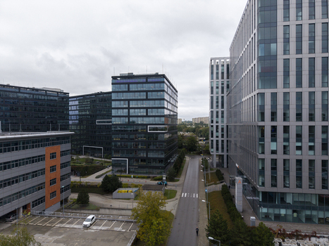Aerial view of modern office buildings in a business park with glass facades and a road in Krakow Lesser Poland Voivode Poland.