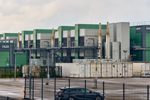 Middenmeer Netherlands 17 May 2026 View of the Microsoft data centers at Agriport featuring large industrial buildings with green accents and ventilation stacks under overcast skies.