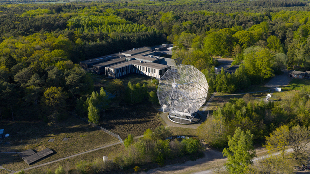 Aerial view of the Radiotelescoop and research facility buildings surrounded by lush green forest in Dwingeloo Drenthe Netherlands.