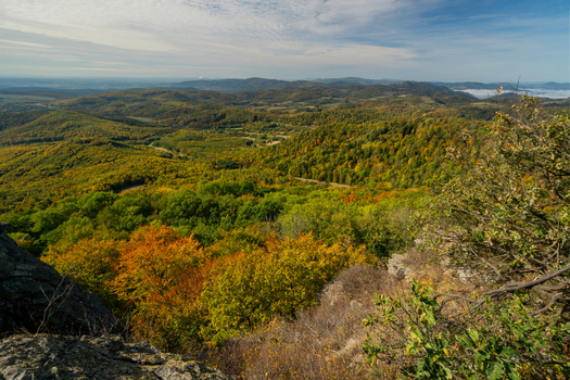 Aerial view of Sitno in Stiavnicke Vrchy with vibrant autumn foliage covering the rolling hills and dense forests in Ilija Banska Bystrica Regio Slovakia.