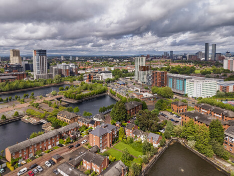 Aerial view of MediaCityUK with modern high rise buildings residential brick apartments and waterways in Salford England United Kingdom. Aerial view of MediaCityUK with modern high rise buildings residential brick apartments and waterways in Salford England United Kingdom.