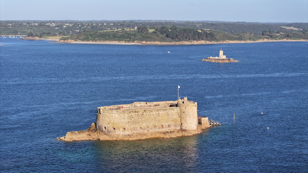 Aerial view of the imposing Ch&acirc;teau du Taureau standing defiant against the relentless sea a sentinel of stone amidst the shimmering waters Plouezoc h Bretagne France.