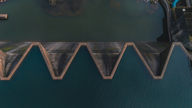 Aerial view of a massive concrete dam wall with a unique labyrinth spillway and dark water in Mooi River KwaZulu Natal South Africa. Aerial view of a massive concrete dam wall with a unique labyrinth spillway and dark water in Mooi River KwaZulu Natal South Africa.