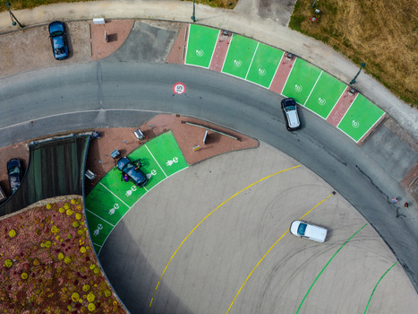 Aerial view of electric vehicle charging station with green parking spaces and cars in Beilen Drenthe Netherlands.