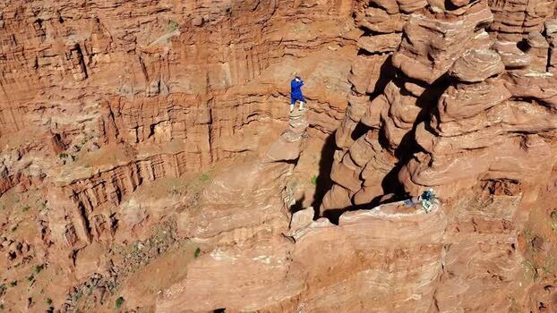 Aerial view of a person on a rock pinnacle at Fisher Towers United States.