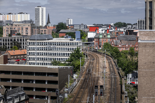 Aerial view of railway tracks curving through the urban landscape with Cuthbert House and surrounding city buildings in Newcastle upon Tyne England United Kingdom. Aerial view of railway tracks curving through the urban landscape with Cuthbert House and surrounding city buildings in Newcastle upon Tyne England United Kingdom.