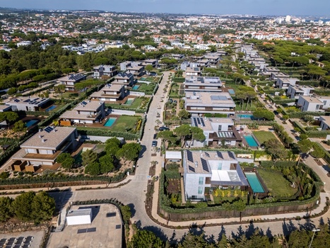 Aerial view of modern villas with private swimming pools and lush gardens in the Quinta da Marinha residential area in Cascais Lisbon Portugal. Aerial view of modern villas with private swimming pools and lush gardens in the Quinta da Marinha residential area in Cascais Lisbon Portugal.