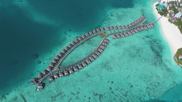 Aerial view of overwater bungalows in a fish shape Maldives. Aerial view of overwater bungalows in a fish shape Maldives.