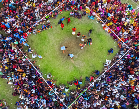 Nilphamari Bangladesh 01 May 2026 Aerial view of a large crowd gathered around a green field for a traditional event with drummers and participants. Nilphamari Bangladesh 01 May 2026 Aerial view of a large crowd gathered around a green field for a traditional event with drummers and participants.