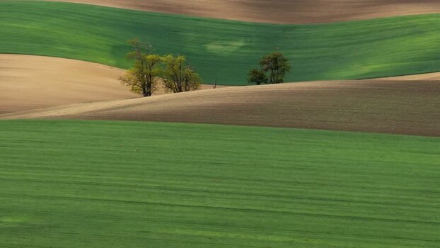 Aerial view of rolling green hills and agricultural fields Czechia.
