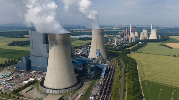 Aerial view of RWE Power AG Kraftwerk Neurath with cooling towers emitting steam surrounded by agricultural fields and industrial infrastructure in Grevenbroich Nordrhein Westfalen Germany. Aerial view of RWE Power AG Kraftwerk Neurath with cooling towers emitting steam surrounded by agricultural fields and industrial infrastructure in Grevenbroich Nordrhein Westfalen Germany.