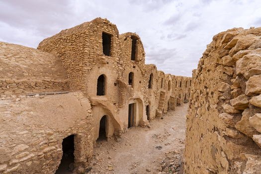 View of the historic Ksar Ouled Soltane with its traditional vaulted stone granaries and arched doorways in the desert landscape of Tataouine Tataouine Governorate Tunisia.