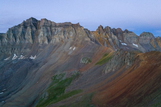 Aerial view of the jagged peaks and rocky slopes of Mt. Sneffels in the Yankee Boy Basin showcasing the rugged alpine terrain of the San Juan Mountains in Ridgway Colorado United States.