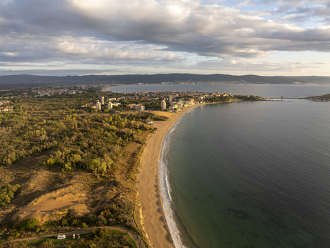 Aerial view of the coastline of Nessebar featuring sandy beaches lush greenery and the Black Sea under a cloudy sky in Nessebar Burgas Bulgaria. Aerial view of the coastline of Nessebar featuring sandy beaches lush greenery and the Black Sea under a cloudy sky in Nessebar Burgas Bulgaria.