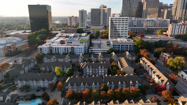 Aerial view of Atlanta housing with downtown skyline featuring residential townhouses autumn trees and modern high rise buildings in Atlanta Georgia United States. Aerial view of Atlanta housing with downtown skyline featuring residential townhouses autumn trees and modern high rise buildings in Atlanta Georgia United States.