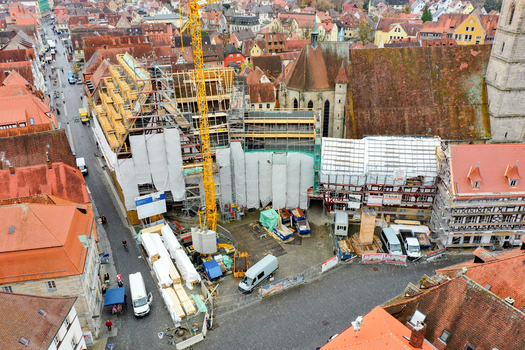 Aerial view of the Rathaus Forchheim under renovation with a yellow crane and scaffolding among historic red tiled roofs in Forchheim Bayern Germany. Aerial view of the Rathaus Forchheim under renovation with a yellow crane and scaffolding among historic red tiled roofs in Forchheim Bayern Germany.