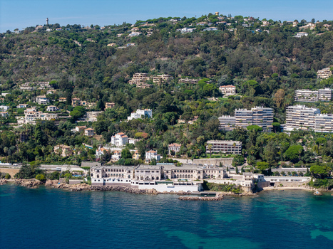 Aerial view of luxury villas nestled among lush Mediterranean vegetation along the rocky coastline of the French Riviera in Antibes Provence Alpes Cote d Azur France. Aerial view of luxury villas nestled among lush Mediterranean vegetation along the rocky coastline of the French Riviera in Antibes Provence Alpes Cote d Azur France.