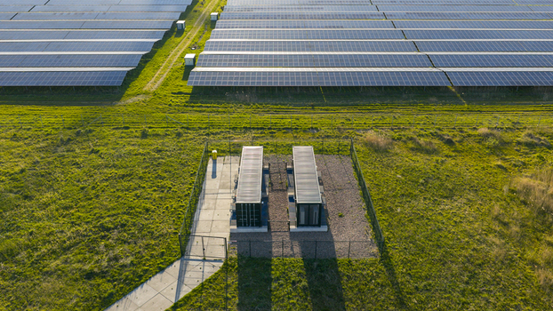 Aerial view of Solar park Delfzijl with rows of photovoltaic panels and utility containers on green grass in Farmsum Groningen Netherlands. Aerial view of Solar park Delfzijl with rows of photovoltaic panels and utility containers on green grass in Farmsum Groningen Netherlands.