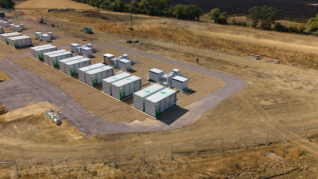 Aerial view of the Eaton Socon Substation featuring rows of white battery energy storage system containers on a gravel site in St. Neots England United Kingdom. Aerial view of the Eaton Socon Substation featuring rows of white battery energy storage system containers on a gravel site in St. Neots England United Kingdom.