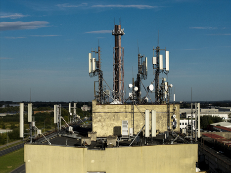 Aerial view of telecommunications antennas and a chimney stack mounted on a rooftop in Krakow Lesser Poland Voivode Poland.