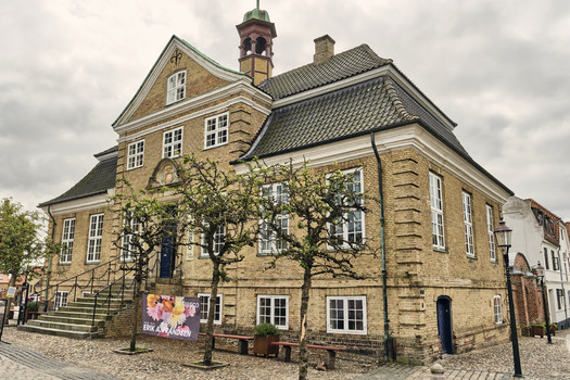 Viborg Denmark 07 August 2026 View of Skovgaard museum a historic yellow brick building with a prominent roof and small trees in front under a cloudy sky. Viborg Denmark 07 August 2026 View of Skovgaard museum a historic yellow brick building with a prominent roof and small trees in front under a cloudy sky.