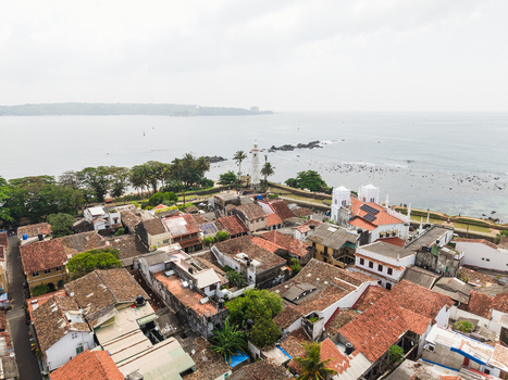 Aerial view of the historic Galle Fort and white lighthouse overlooking the Indian Ocean with traditional red tiled rooftops Galle Southern Province Sri Lanka. Aerial view of the historic Galle Fort and white lighthouse overlooking the Indian Ocean with traditional red tiled rooftops Galle Southern Province Sri Lanka.