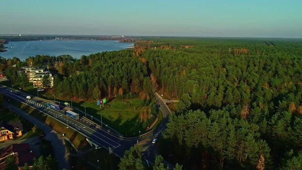 Aerial view of highway through pine forest in Latvia.