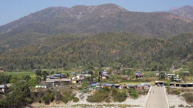 View of a rural village and forested mountains Nepal.