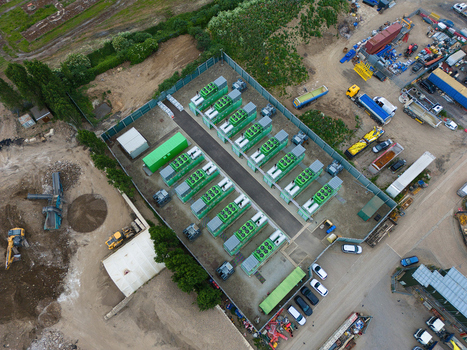 Aerial view of Damhead Creek Power Station Battery Energy Storage Systems BESS featuring rows of green battery containers within a fenced compound Rochester England United Kingdom. Aerial view of Damhead Creek Power Station Battery Energy Storage Systems BESS featuring rows of green battery containers within a fenced compound Rochester England United Kingdom.