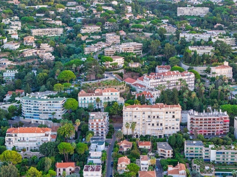 Aerial view of the residential buildings and lush vegetation in the coastal city of Cannes Provence Alpes Cote d Azur France. Aerial view of the residential buildings and lush vegetation in the coastal city of Cannes Provence Alpes Cote d Azur France.