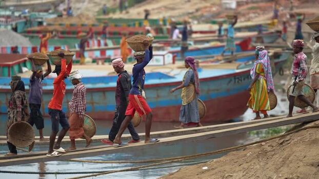 View of workers carrying sand baskets at Aminbazar Bangladesh. View of workers carrying sand baskets at Aminbazar Bangladesh.