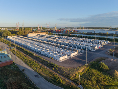 Aerial view of the Cargovil battery energy storage system featuring rows of white containers industrial infrastructure and power lines near a canal in Vilvoorde Vlaanderen Belgium. Aerial view of the Cargovil battery energy storage system featuring rows of white containers industrial infrastructure and power lines near a canal in Vilvoorde Vlaanderen Belgium.