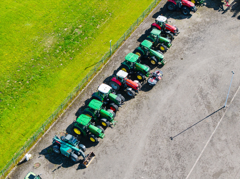 Kekava Kekava Municipality Latvia 05 July 2026 Aerial view of a row of agricultural tractors and machinery parked at a dealership in a sunny outdoor lot. Kekava Kekava Municipality Latvia 05 July 2026 Aerial view of a row of agricultural tractors and machinery parked at a dealership in a sunny outdoor lot.