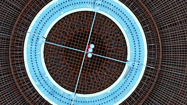 Aerial view of wind turbine foundation with circular rebar reinforcement and concrete base in Latvija. Aerial view of wind turbine foundation with circular rebar reinforcement and concrete base in Latvija.