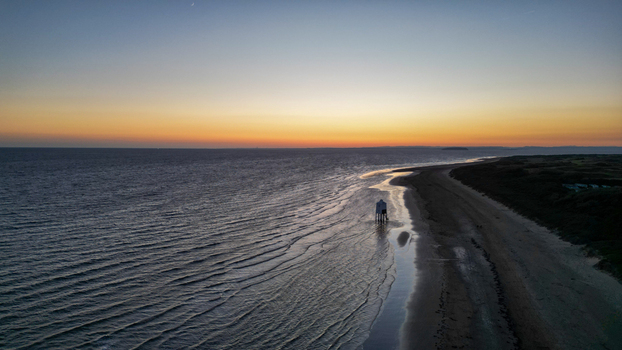 Aerial view of the iconic Burnham on Sea Low Lighthouse standing on the sandy beach during a vibrant golden hour sunset in Burnham on Sea England United Kingdom. Aerial view of the iconic Burnham on Sea Low Lighthouse standing on the sandy beach during a vibrant golden hour sunset in Burnham on Sea England United Kingdom.