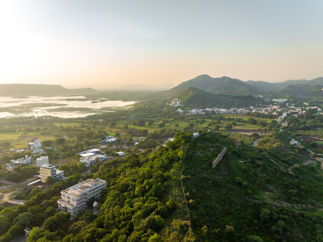 Aerial view of the lush green hills and water bodies surrounding the city of Udaipur Rajasthan India.