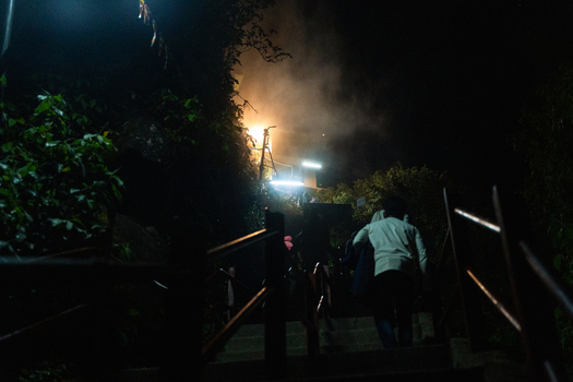 View of pilgrims climbing the illuminated stone stairs of Adam s Peak at night through dense foliage and mist in Ratnapura Sabaragamuwa Province Sri Lanka. View of pilgrims climbing the illuminated stone stairs of Adam s Peak at night through dense foliage and mist in Ratnapura Sabaragamuwa Province Sri Lanka.