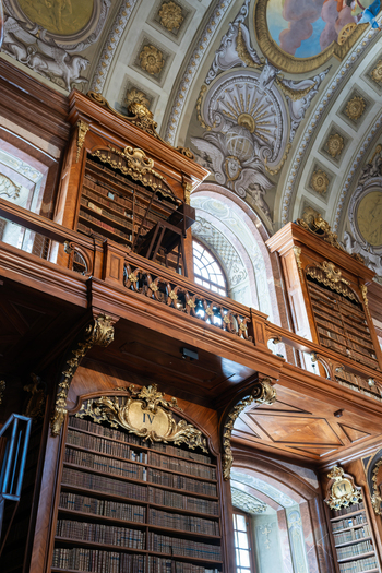 Wien Austria 26 April 2026 View of the Austrian National Library featuring ornate baroque wooden bookshelves gold leaf ornaments and a magnificent painted vaulted ceiling. Wien Austria 26 April 2026 View of the Austrian National Library featuring ornate baroque wooden bookshelves gold leaf ornaments and a magnificent painted vaulted ceiling.